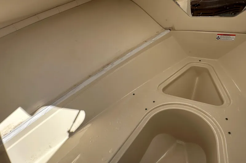 Slide: The Image of Interior view of a 2009 Scarab Sport 30 boat, featuring storage compartments. - 51
