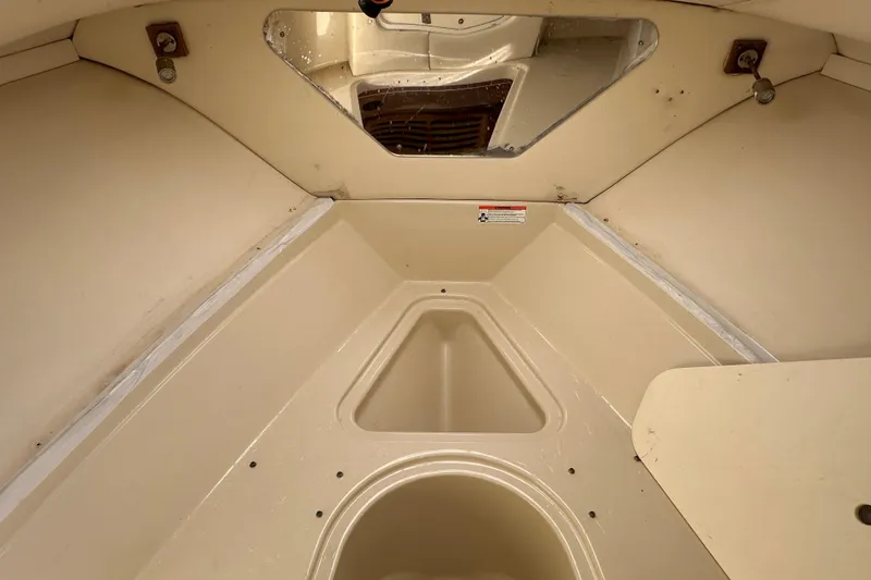 Slide: The Image of 2009 Scarab Sport 30 boat interior, featuring beige storage compartments and sleek design. - 52