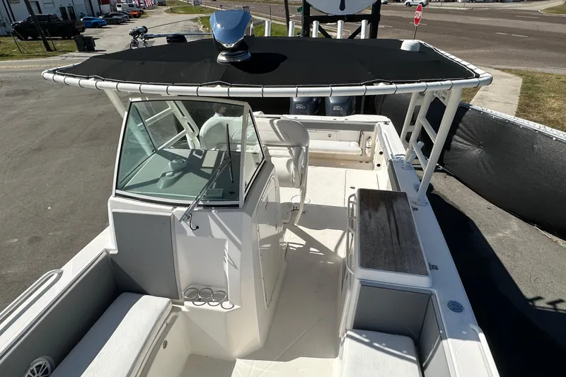 Slide: The Image of 2009 Scarab Sport 30 boat with black canopy and spacious deck layout. - 59