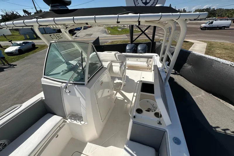 Slide: The Image of 2009 Scarab Sport 30 boat interior with seating, console, and dual engines. - 60