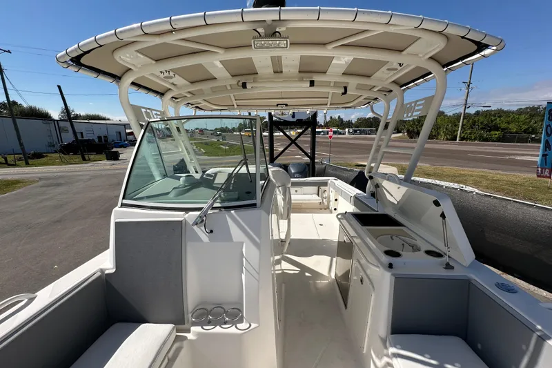 Slide: The Image of 2009 Scarab Sport 30 boat interior with seating, helm, and canopy. - 61