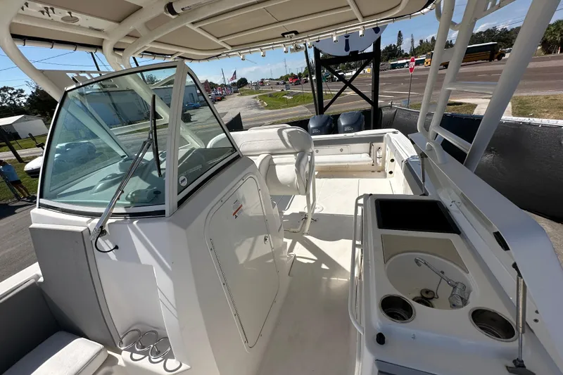 Slide: The Image of 2009 Scarab Sport 30 boat interior with seating, console, and dual engines. - 63