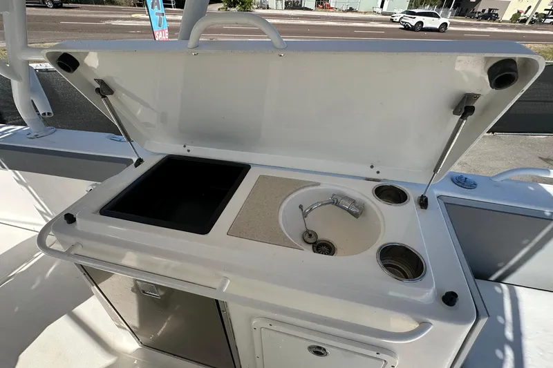 Slide: The Image of 2009 Scarab Sport 30 boat kitchenette with sink and storage. - 64