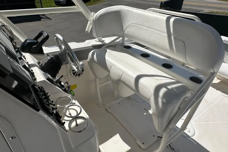 Slide: The Image of 2009 Scarab Sport 30 boat interior with white seating and steering console. - 69
