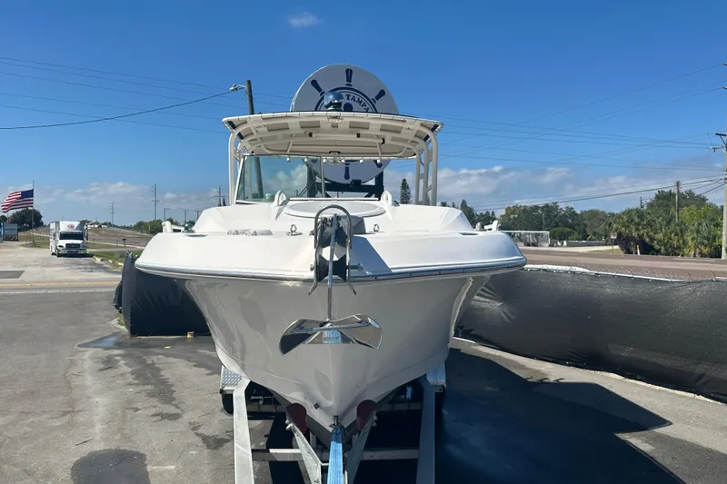 Slide: The Image of 2009 Scarab Sport 30 boat on trailer, parked outdoors under clear blue sky. - 7