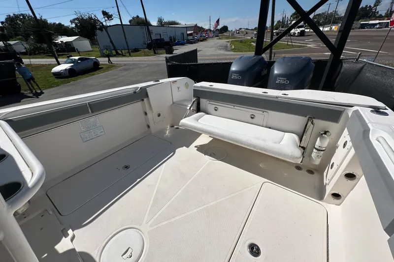 Slide: The Image of 2009 Scarab Sport 30 boat interior with dual Yamaha 250 engines, parked outdoors. - 70