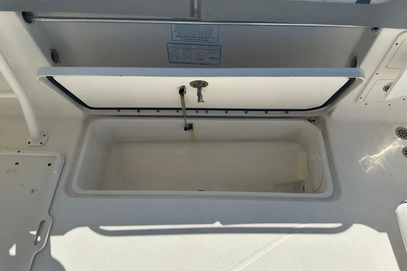 Slide: The Image of Open storage compartment on a 2009 Scarab Sport 30 boat, showing interior space. - 74