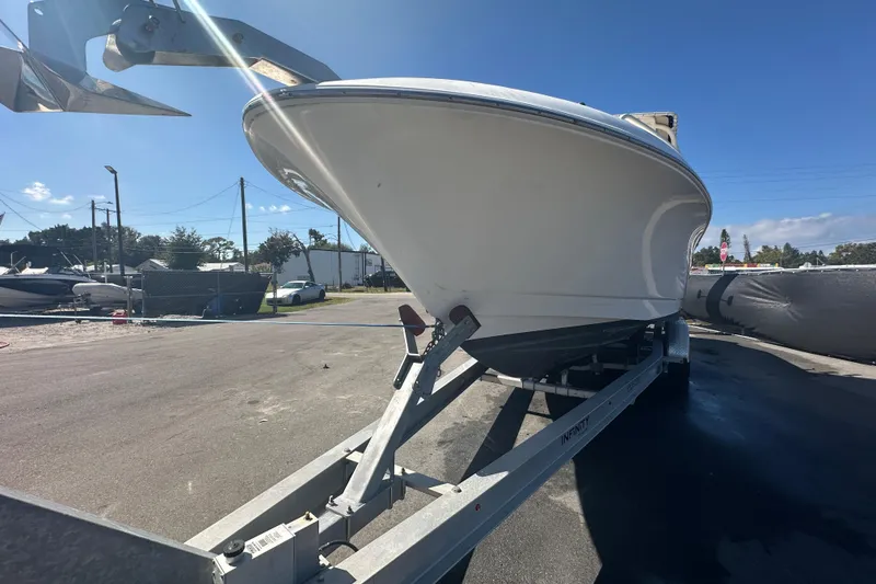 Slide: The Image of 2009 Scarab Sport 30 boat on trailer under clear blue sky. - 8