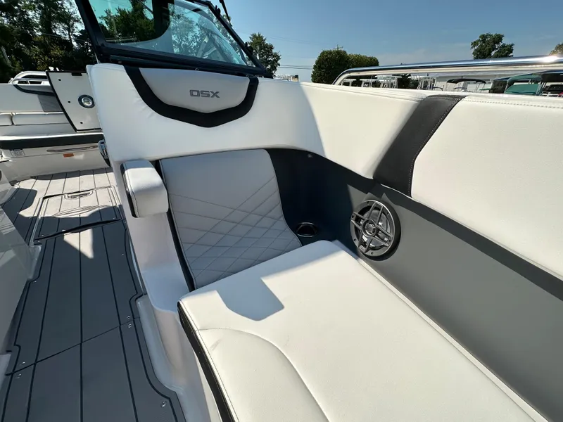 Slide: The Image of 2023 Chaparral 270 OSX boat interior with white seating and speaker detail. - 11