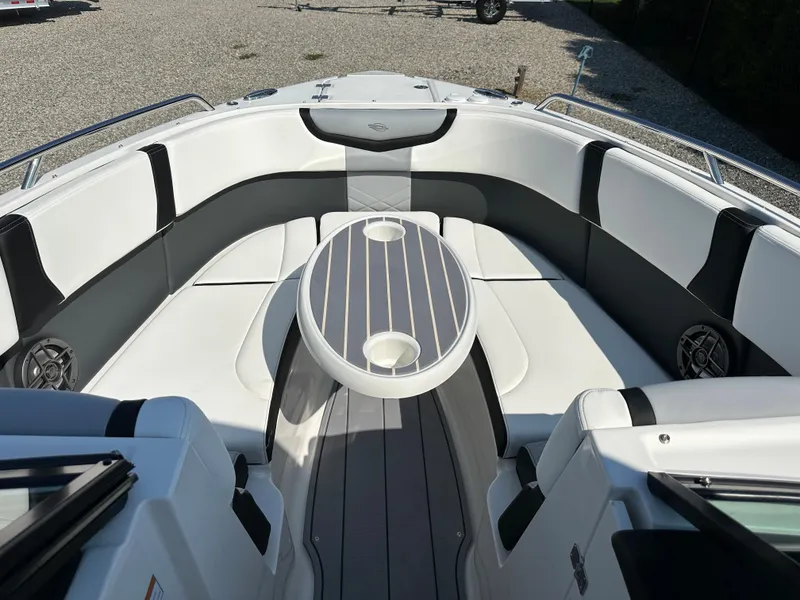 Slide: The Image of 2023 Chaparral 270 OSX boat interior with sleek seating and modern table design. - 15