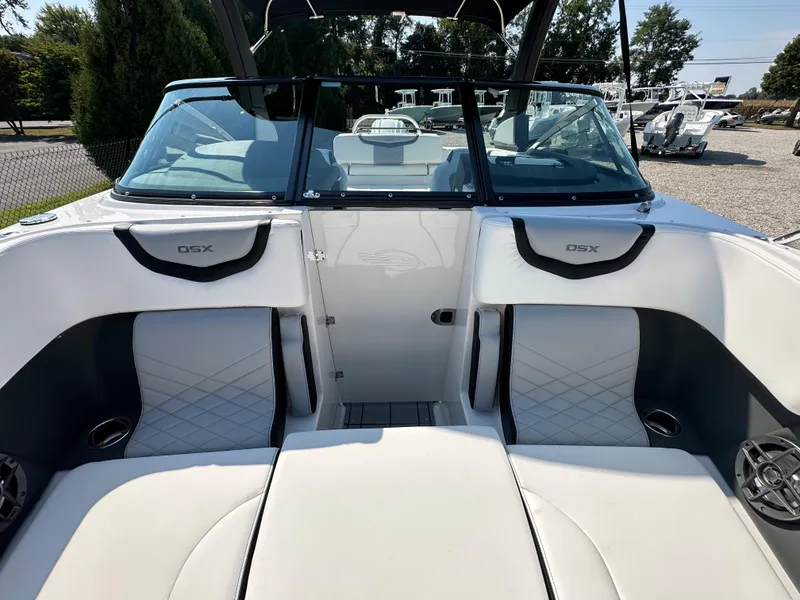 Slide: The Image of 2023 Chaparral 270 OSX boat interior with white seating and sleek design. - 17
