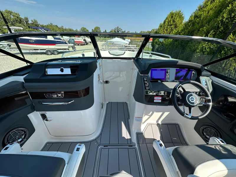 Slide: The Image of 2023 Chaparral 270 OSX boat cockpit with modern controls and sleek design. - 21
