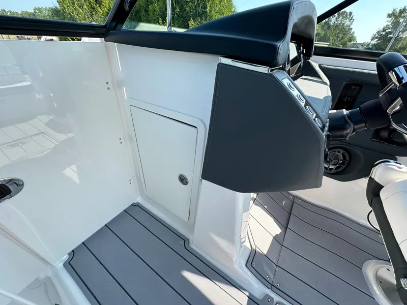 Slide: The Image of 2023 Chaparral 270 OSX boat interior with sleek dashboard and modern design. - 22