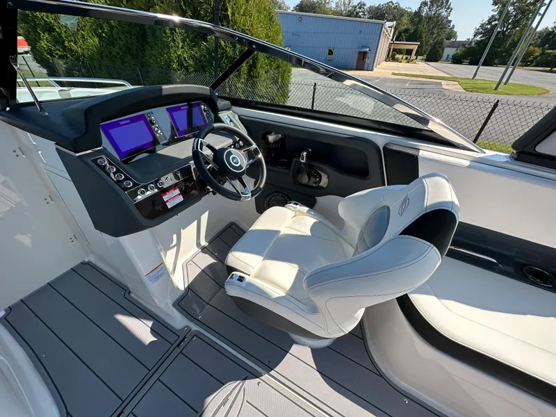 Slide: The Image of 2023 Chaparral 270 OSX boat cockpit with modern controls and comfortable seating. - 24