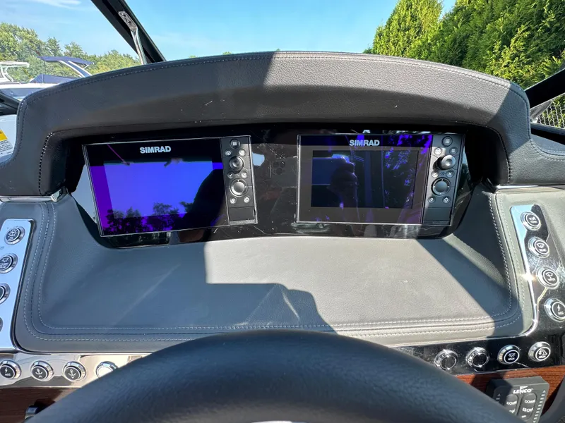 Slide: The Image of 2023 Chaparral 270 OSX dashboard with dual Simrad displays and control panel. - 26