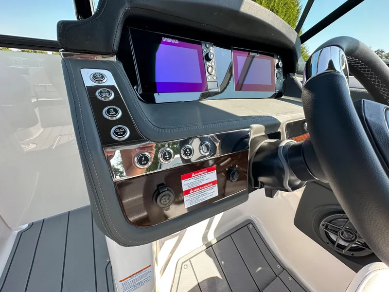 Slide: The Image of 2023 Chaparral 270 OSX boat dashboard with dual Simrad displays and control panel. - 29