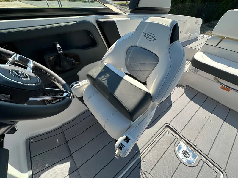 Slide: The Image of 2023 Chaparral 270 OSX boat interior with steering wheel and luxurious seating. - 30