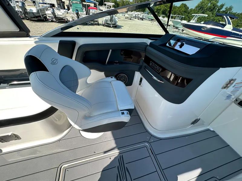 Slide: The Image of 2023 Chaparral 270 OSX boat interior with sleek helm and comfortable captain's chair. - 31