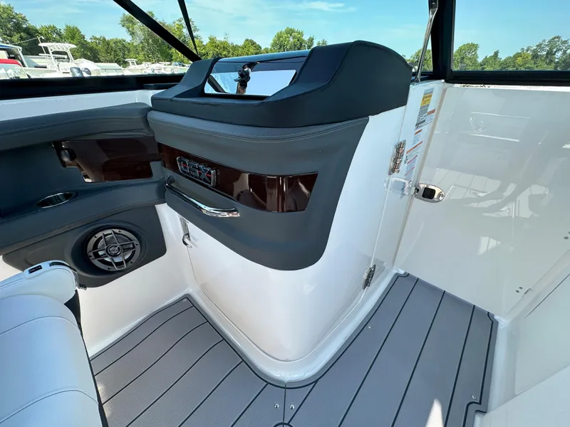Slide: The Image of 2023 Chaparral 270 OSX boat interior with sleek dashboard and modern design. - 32