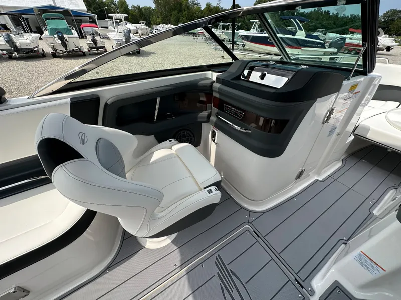 Slide: The Image of 2023 Chaparral 270 OSX boat interior with sleek helm and comfortable seating. - 38