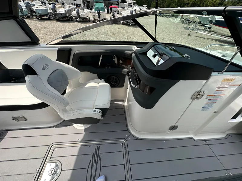 Slide: The Image of 2023 Chaparral 270 OSX boat interior with helm and seating area. - 39