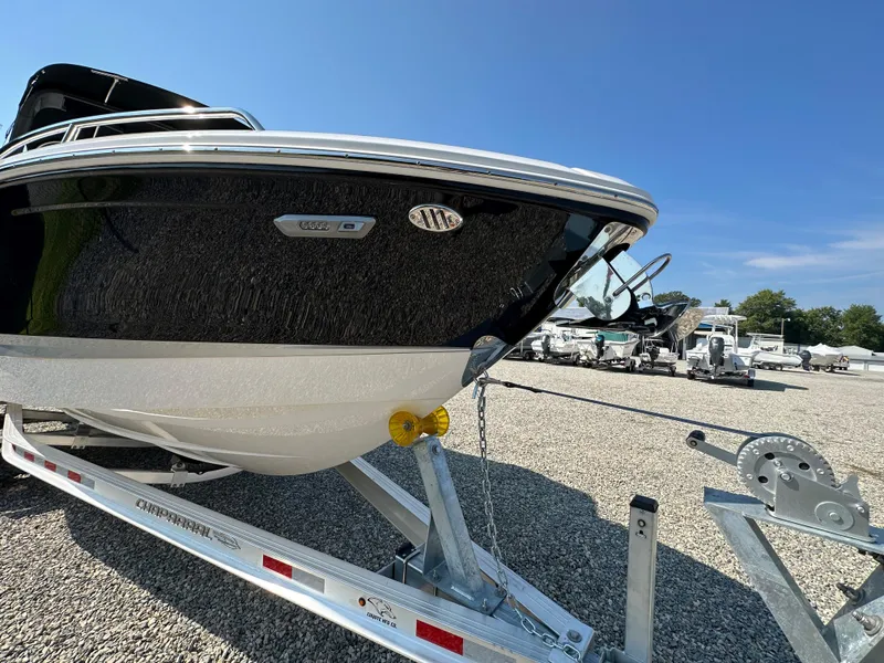 Slide: The Image of 2023 Chaparral 270 OSX boat on trailer in sunny outdoor setting. - 4