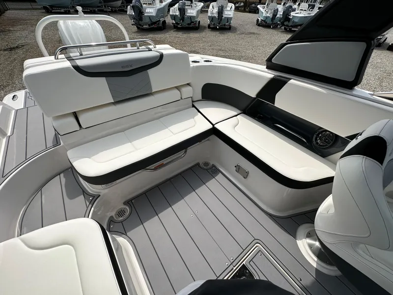 Slide: The Image of 2023 Chaparral 270 OSX boat interior with sleek white seating and modern design. - 42