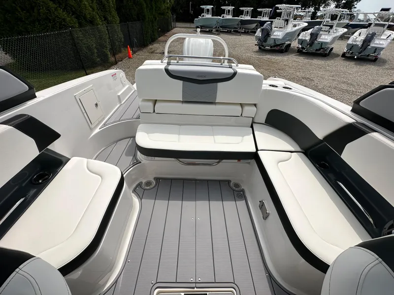 Slide: The Image of 2023 Chaparral 270 OSX boat interior with white seating and sleek design. - 43