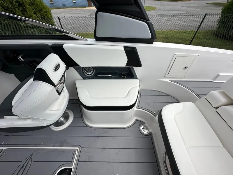 Slide: The Image of 2023 Chaparral 270 OSX boat interior with white seating and modern dashboard. - 49