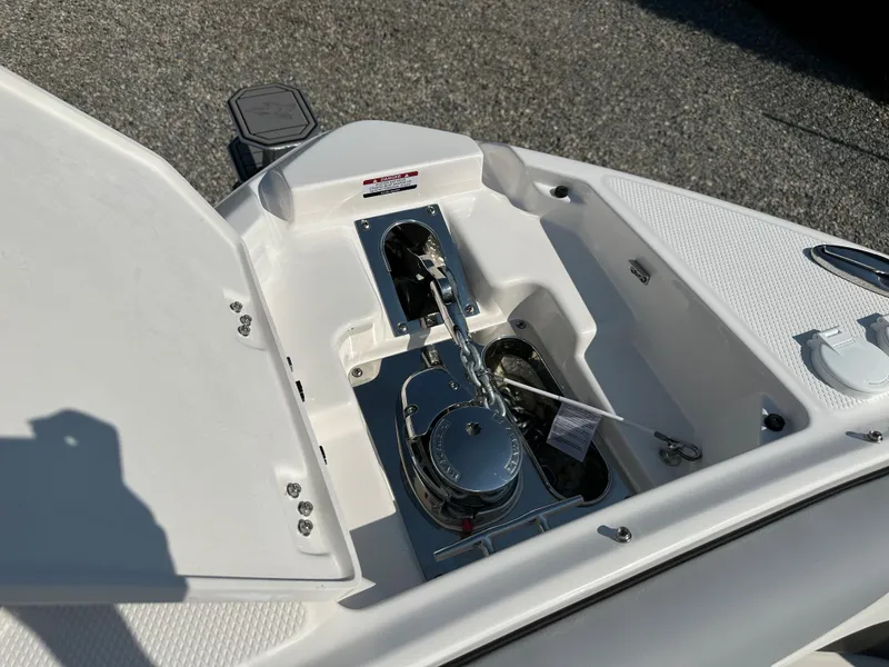 Slide: The Image of 2023 Chaparral 270 OSX boat anchor compartment with open hatch, showcasing anchor mechanism. - 6