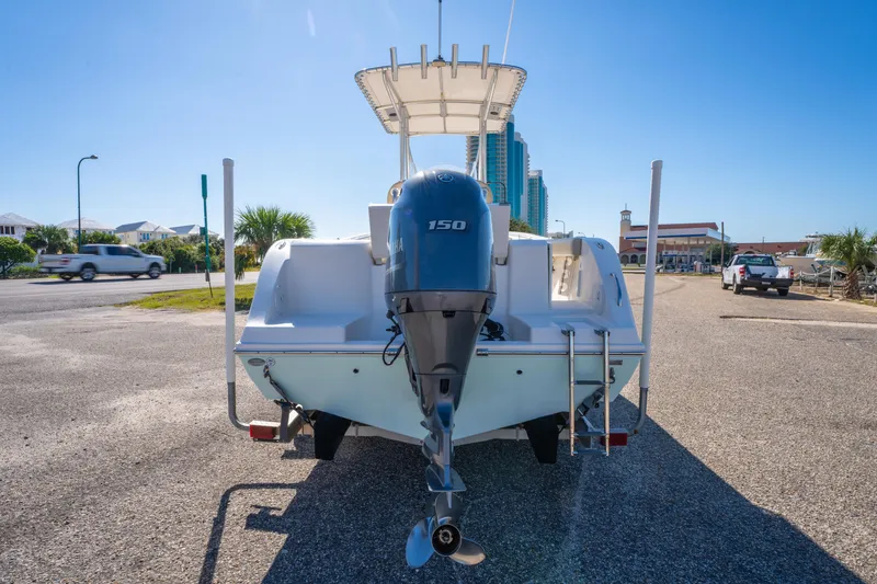 Slide: The Image of 2017 Cobia 220 Center Console boat with Yamaha 150 engine, parked outdoors. - 10