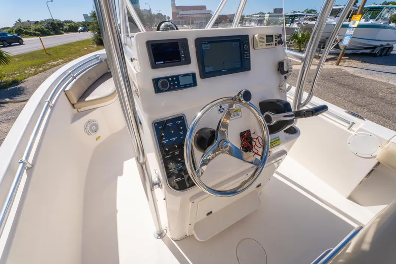 Slide: The Image of 2017 Cobia 220 Center Console boat dashboard with steering wheel and navigation controls. - 12