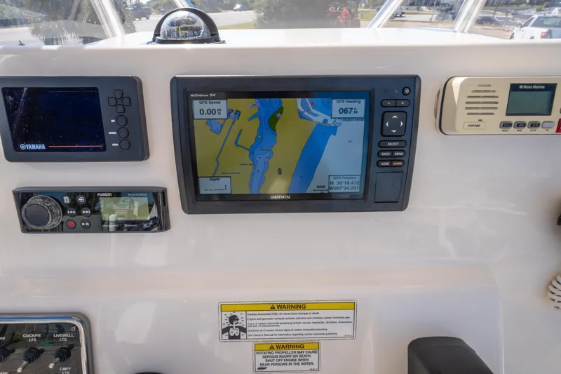 Slide: The Image of 2017 Cobia 220 Center Console dashboard with GPS and navigation equipment. - 14