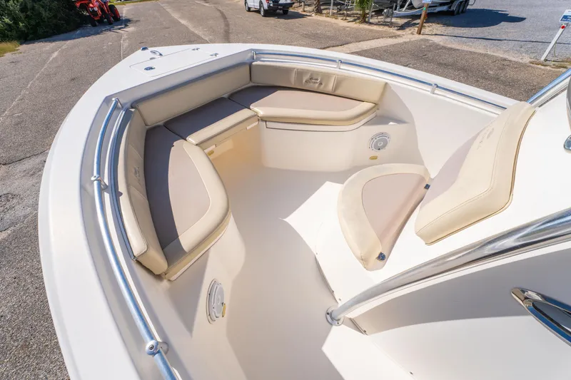 Slide: The Image of 2017 Cobia 220 Center Console boat interior with cushioned seating and stainless steel railings. - 16