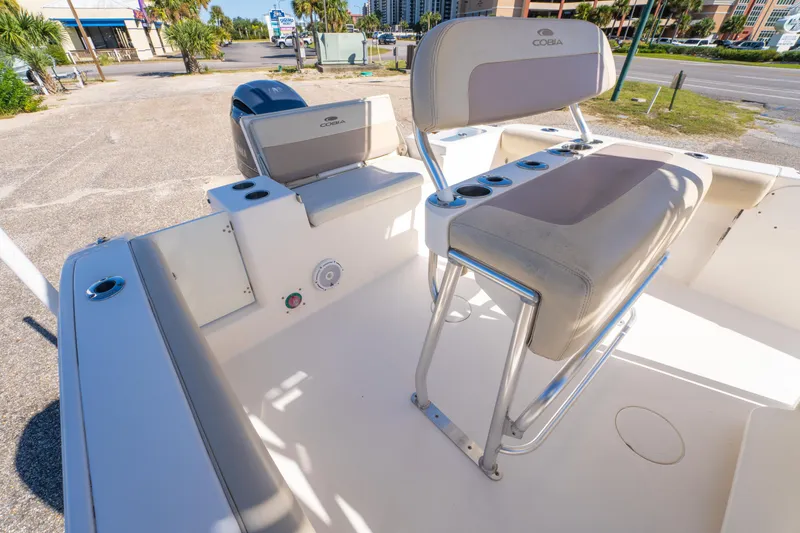 Slide: The Image of 2017 Cobia 220 Center Console boat interior with seating and cup holders. - 18