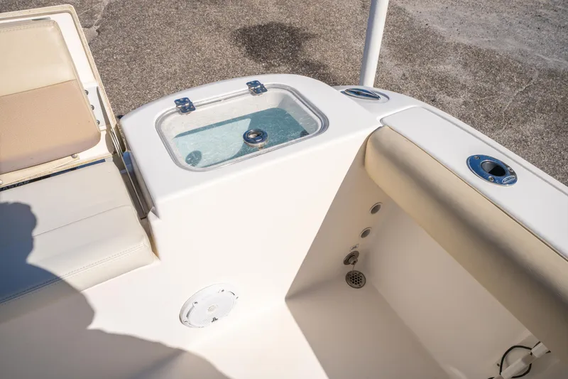 Slide: The Image of 2017 Cobia 220 Center Console boat interior with livewell and seating. - 20