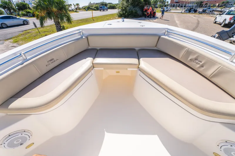 Slide: The Image of 2017 Cobia 220 Center Console boat with cushioned seating and open deck view. - 22