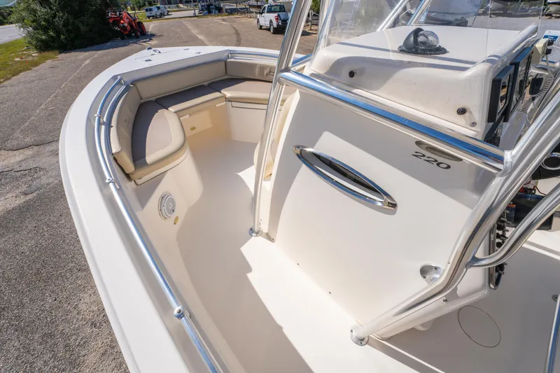 Slide: The Image of 2017 Cobia 220 Center Console boat interior with seating and console details. - 23