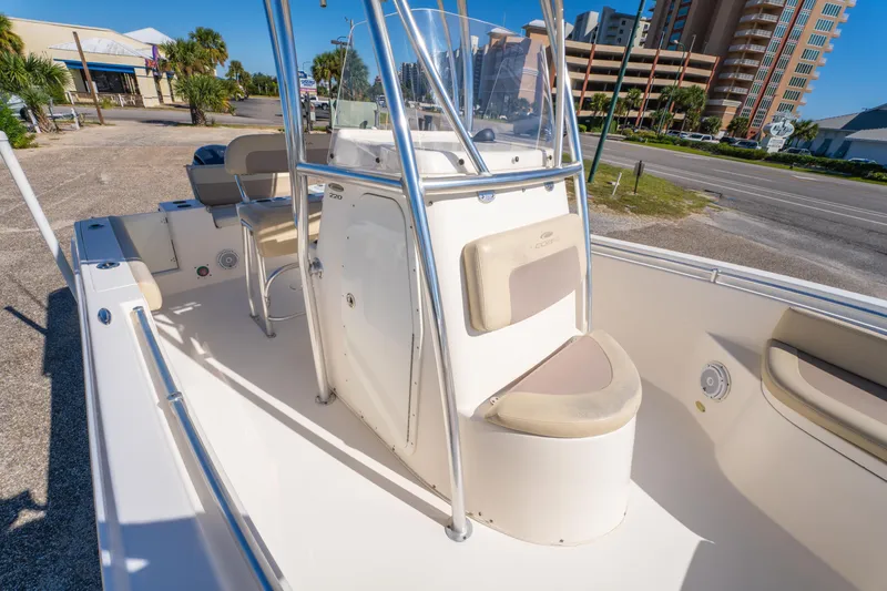 Slide: The Image of 2017 Cobia 220 Center Console boat interior with seating and console view. - 26
