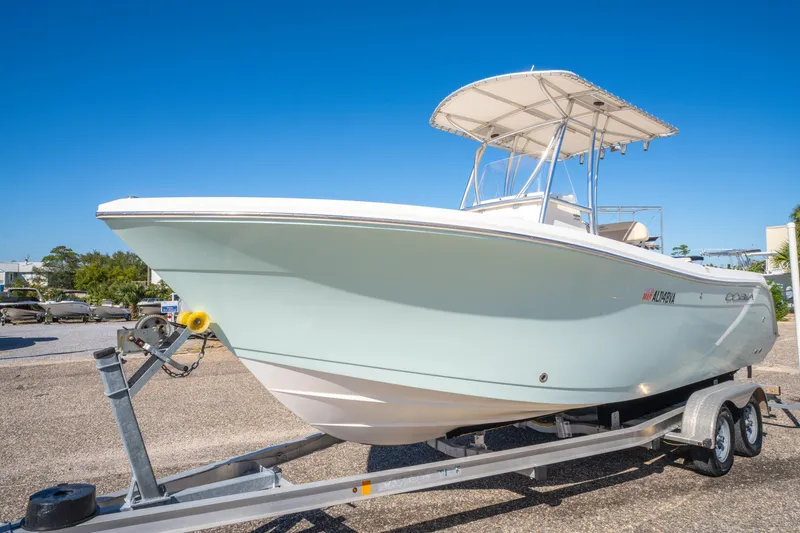 Slide: The Image of 2017 Cobia 220 Center Console boat on trailer under clear blue sky. - 3