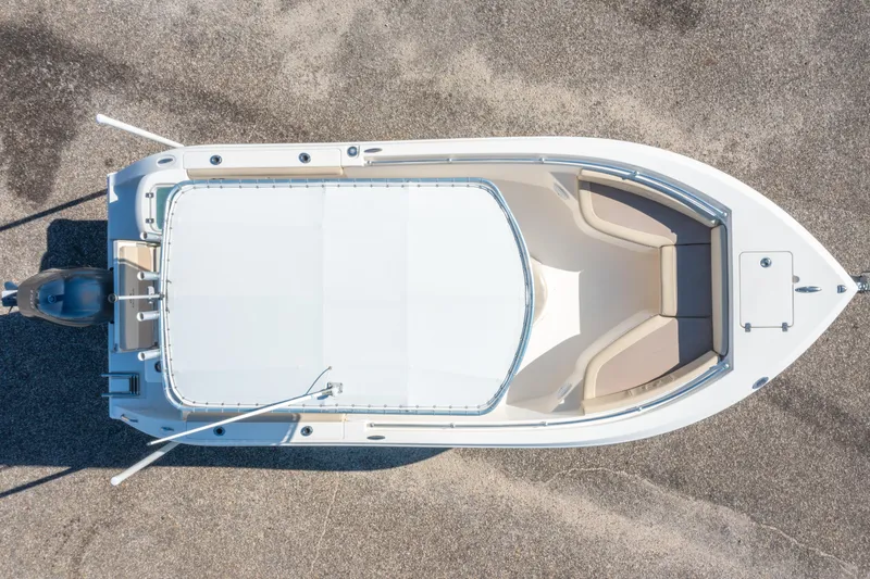 Slide: The Image of Overhead view of a 2017 Cobia 220 Center Console boat on a textured surface. - 5
