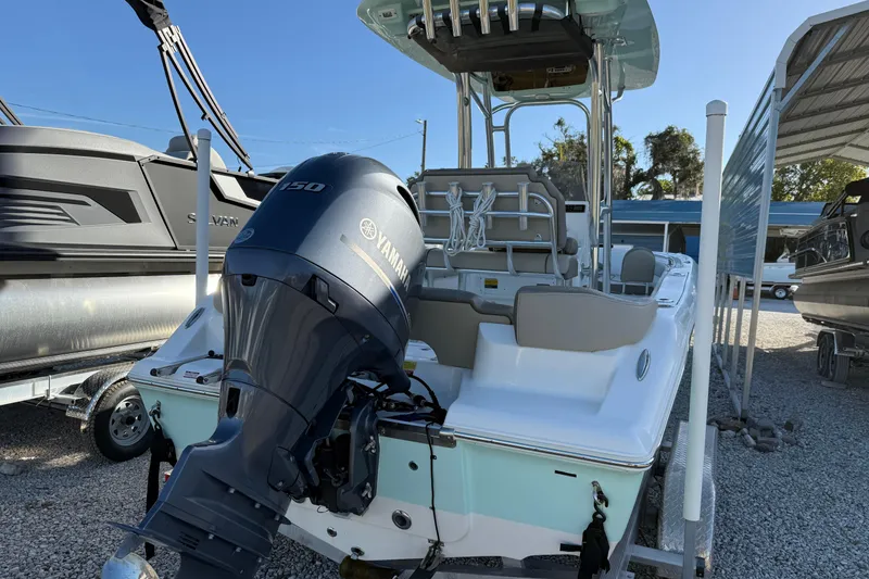 Slide: The Image of 2022 Key West 203 FS boat with Yamaha 150 engine, parked in a marina. - 13