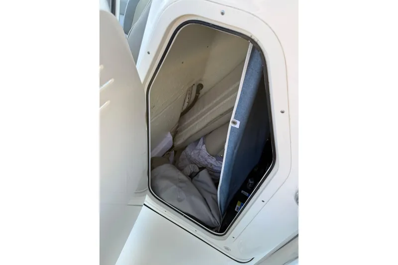 Slide: The Image of 2022 Key West 203 FS boat storage compartment with open hatch and interior view. - 14