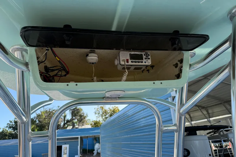 Slide: The Image of 2022 Key West 203 FS boat console with radio and wiring, under a blue canopy. - 16