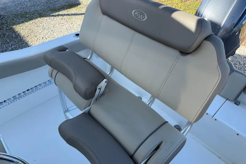 Slide: The Image of 2022 Key West 203 FS boat seat with gray upholstery and adjustable armrests. - 17