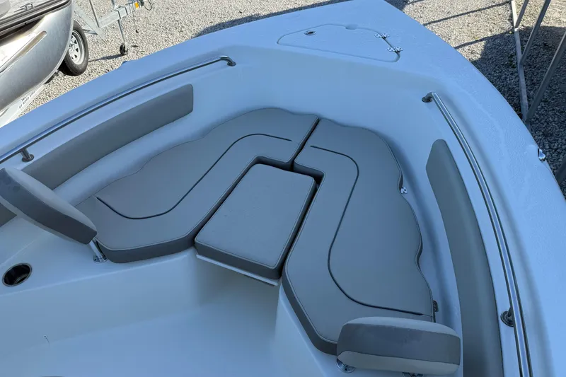 Slide: The Image of 2022 Key West 203 FS boat with cushioned seating in the bow area. - 3