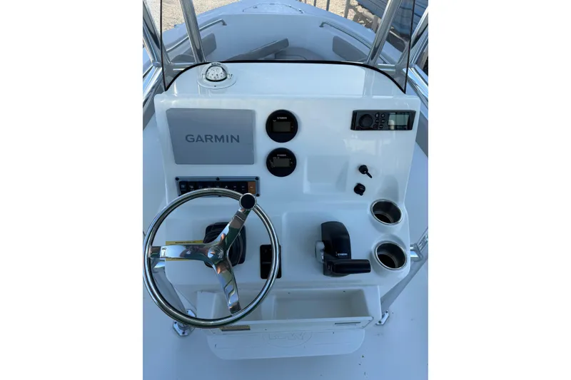 Slide: The Image of 2022 Key West 203 FS boat console with Garmin display and steering wheel. - 8