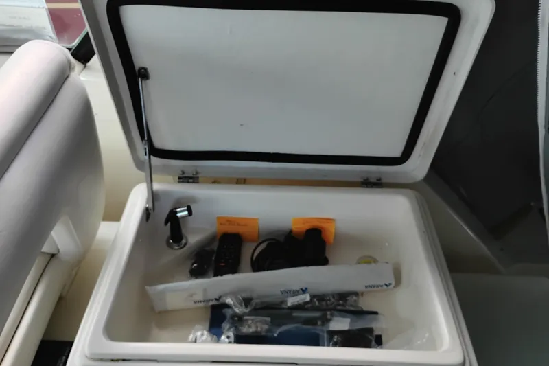 Slide: The Image of Storage compartment in a 1997 Tiara 3700 Open boat, containing various items. - 12