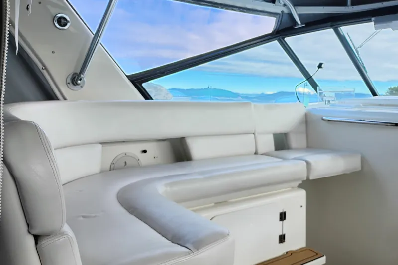 Slide: The Image of Interior of 1997 Tiara 3700 Open yacht with white seating and scenic window view. - 13