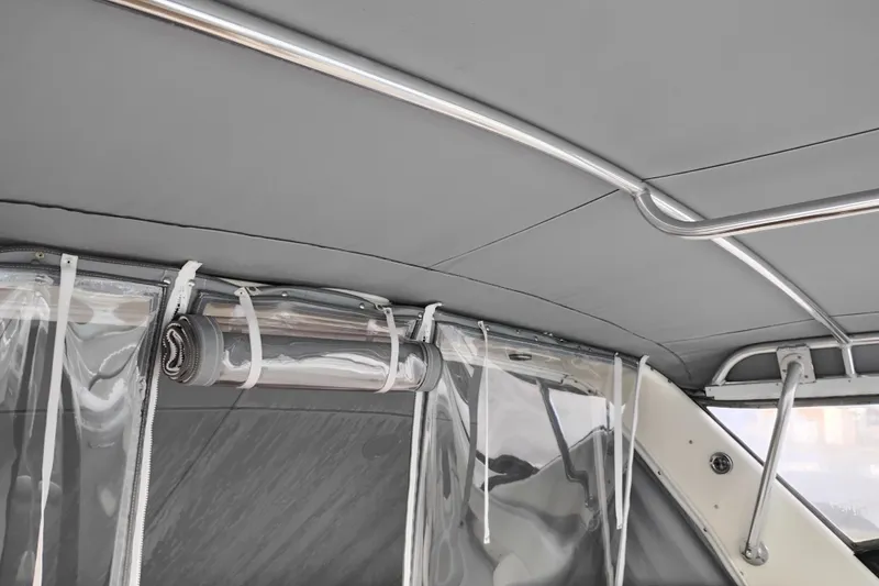 Slide: The Image of Interior view of a 1997 Tiara 3700 Open boat with rolled-up clear vinyl panels. - 14
